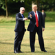 US President Donald Trump (R) gestures as he talks with US Ambassador to the United Kingdom Woody Johnson (L) preparing to board Marine One to depart the US ambassador’s residence Winfield House in London on July 13, 2018. -
